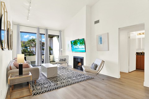 A living room with a fireplace and a television at Twelve One Ten Rochester, California