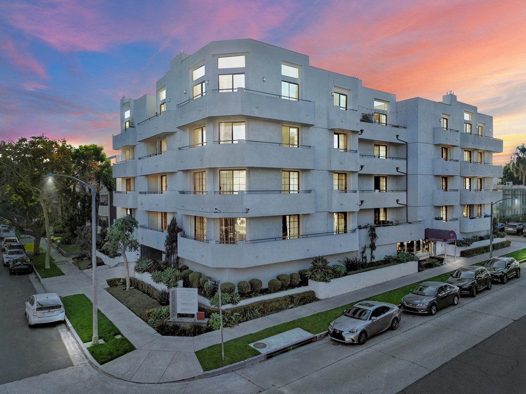 A modern apartment building with cars parked in front at Beverly Wooster Apartments, Los Angeles, 90035