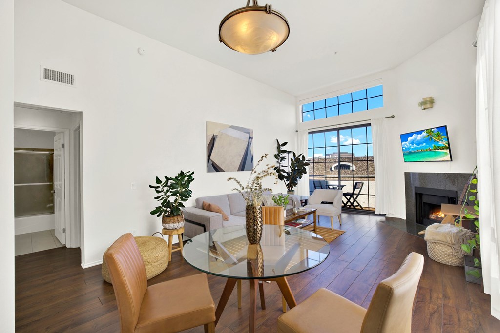 A living room with a glass table and chairs at Beverly Wooster Apartments, California
