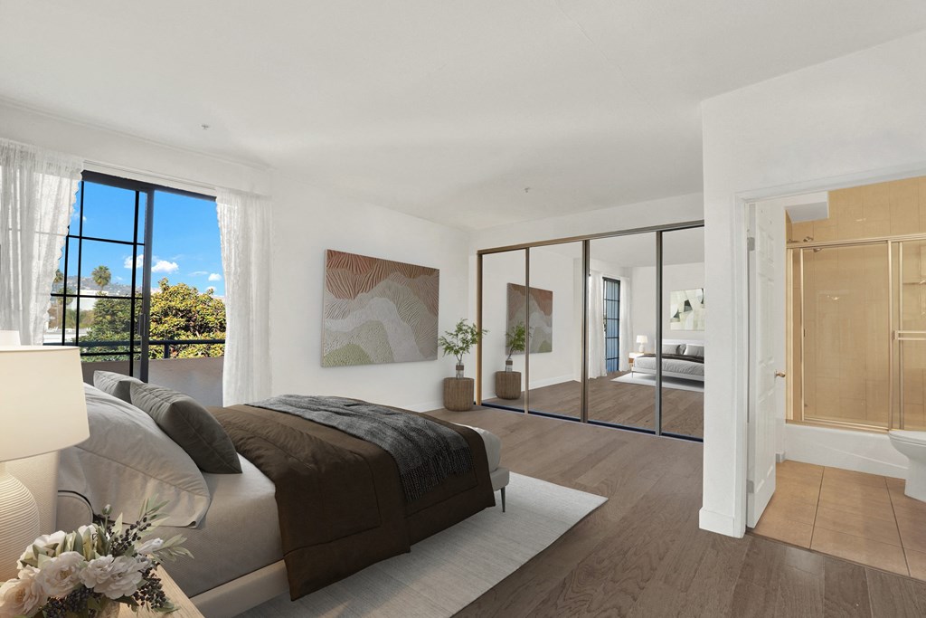 A bedroom with a large bed and a view of the outdoors through a window A bedroom with a large bed and a view of the outdoors through a window at Beverly Wooster Apartments, California 90035