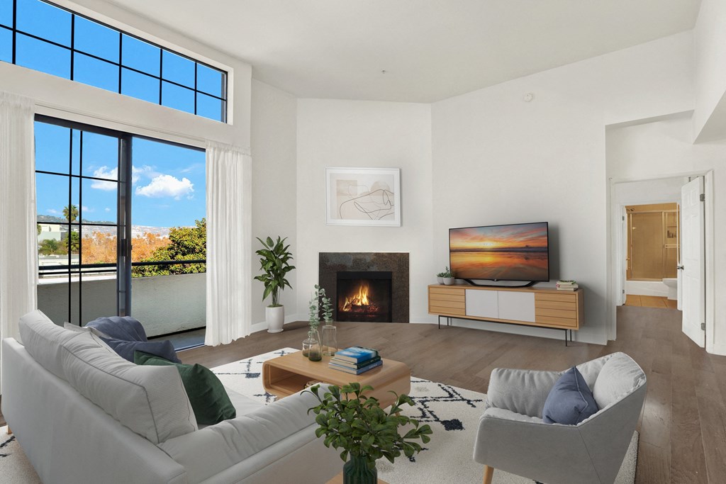 A modern living room with a fireplace and a large window at Beverly Wooster Apartments, California 90035