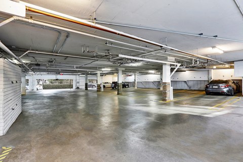 A spacious garage with concrete floors and multiple parking spaces at Peach Tree Court, Los Angeles, CA 90024