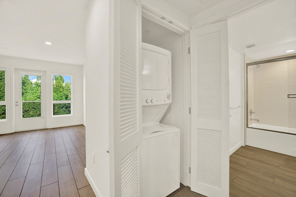 A white bathroom with a toilet and sink at The Urbanpolitan, Los Angeles, CA