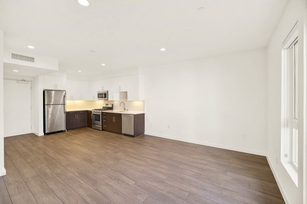 A kitchen with wooden floors and white walls at The Urbanpolitan, California 90036