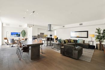 A modern living room with a dark wood floor and furniture at The Urbanpolitan, Los Angeles, CA 90036