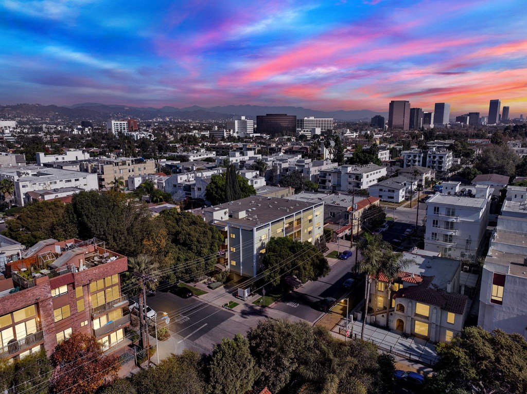 A cityscape with buildings and a street in the foreground at Wooster Encore Apartments, Los Angeles