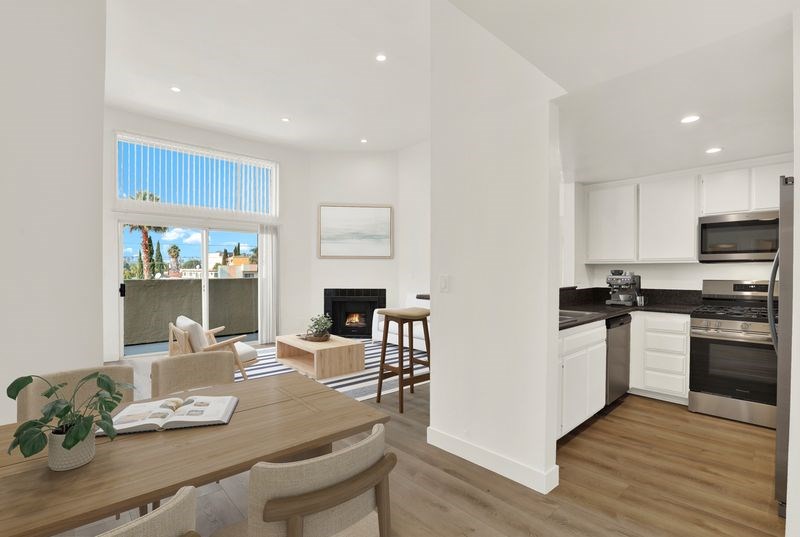 A modern kitchen with a dining table and chairs.