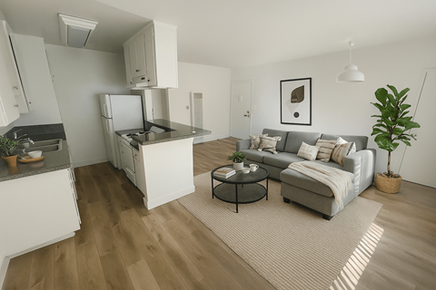 A modern living room with a grey couch and a coffee table.