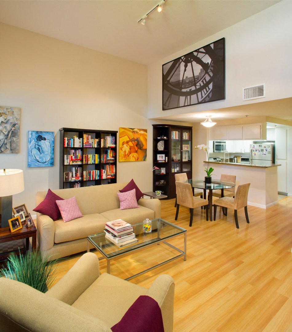 Apartment living room with high ceilings, kitchen and dining area