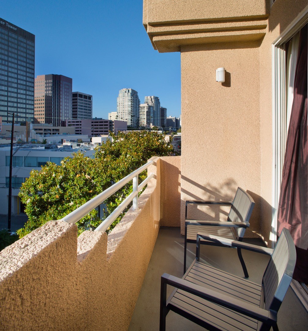Apartment balcony with street and treetop views