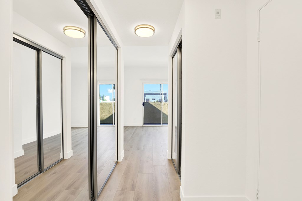 A long hallway with sliding doors on both sides.