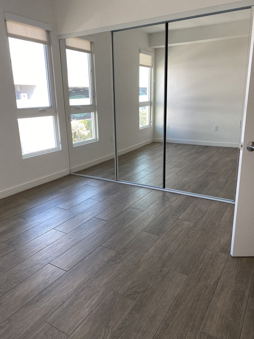 Apartment bedroom with mirrored closet doors
