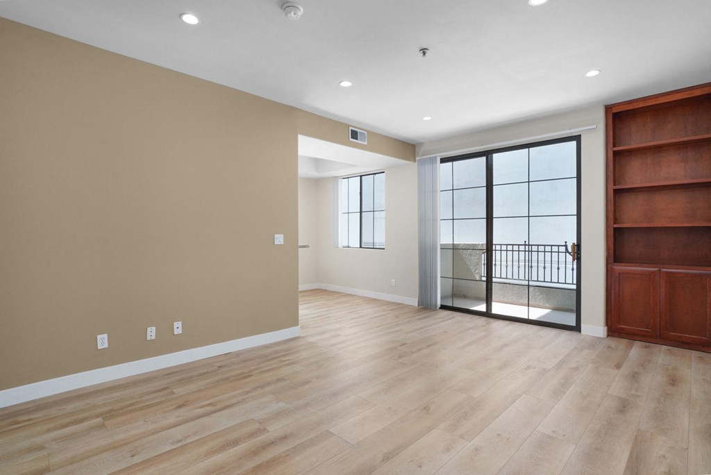 Apartment living room with built-in cabinets and balcony