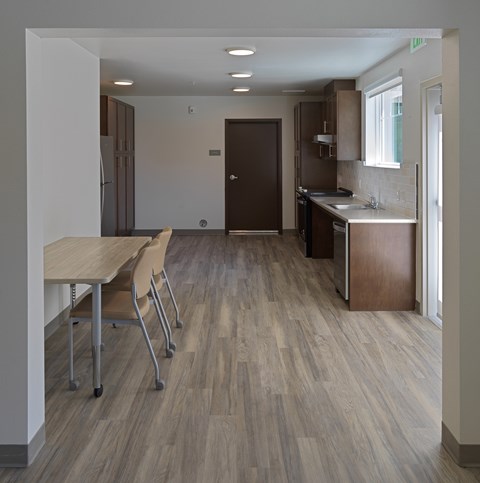 A kitchen with a table and chairs in the foreground.
