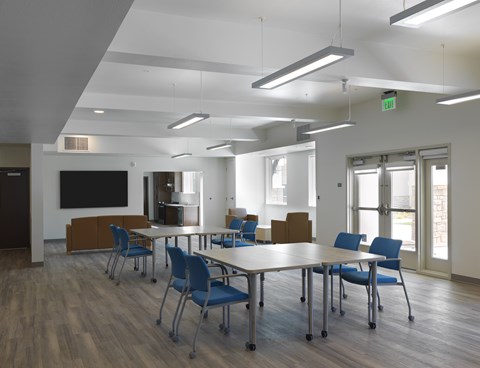 A conference room with a long table and chairs.