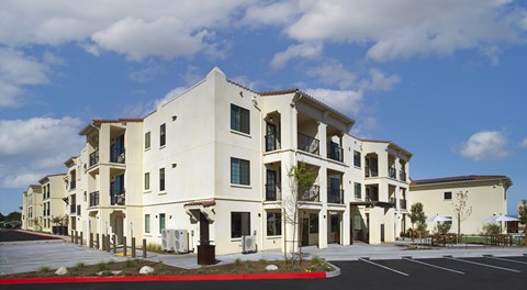 A white building with a red stripe in front.