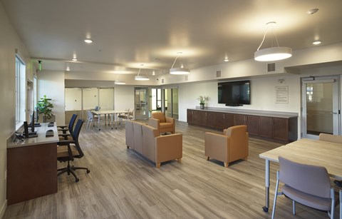 A modern office space with wooden floors and furniture.