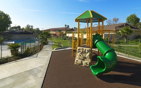a playground with a slide and a pool