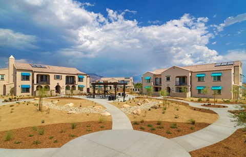 a group of houses in a courtyard with a walkway