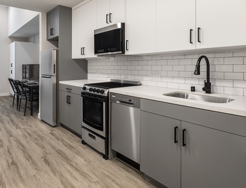 A modern kitchen with a stainless steel oven and dishwasher.