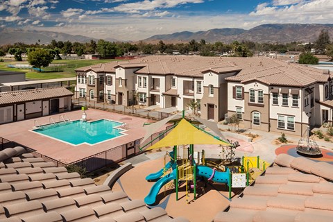 an aerial view of an apartment complex with a swimming pool