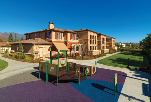 a playground in front of a large house