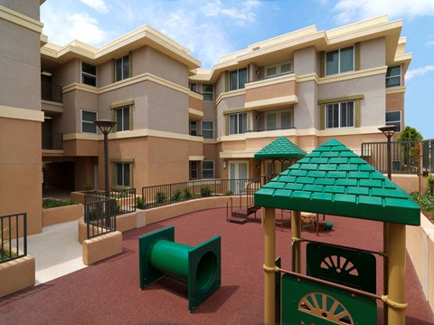 a large building with a playground in front of it
