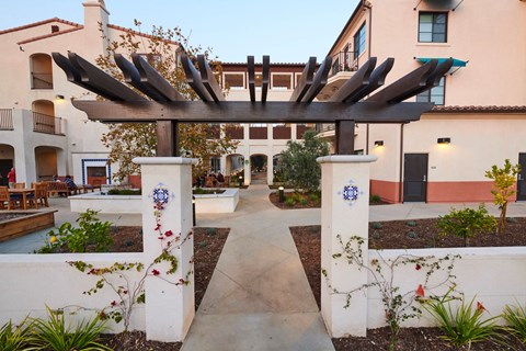 a view of the courtyard of an apartment building with a walkway and a gate