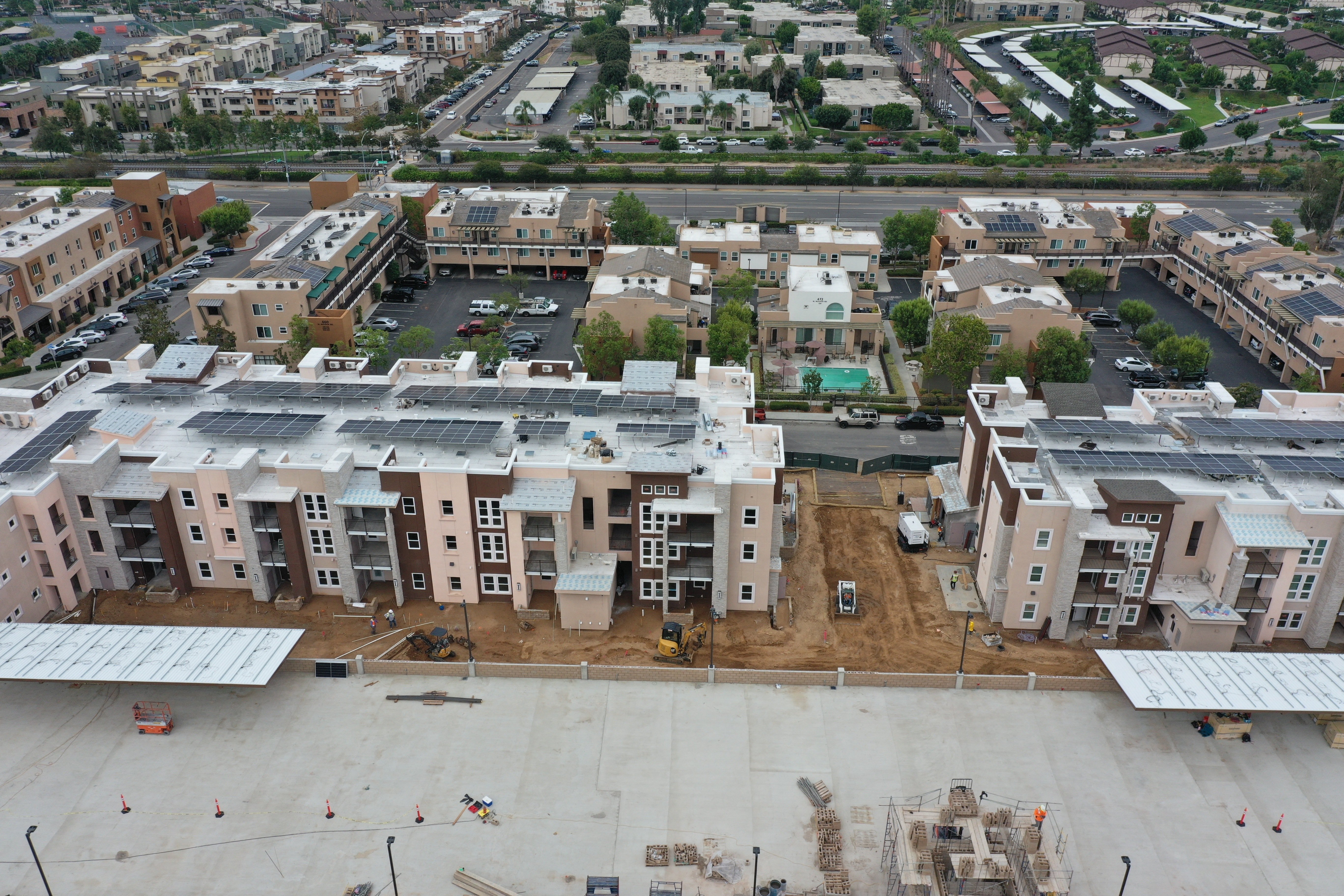 an aerial view of a city with buildings with solar panels on the roof