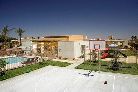a backyard with a basketball court and a pool