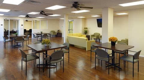 a dining room with tables and chairs and chairs