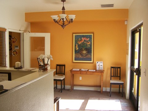 a dining room with a table and chairs and a painting on the wall