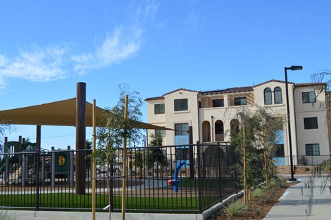 a playground in front of an apartment building