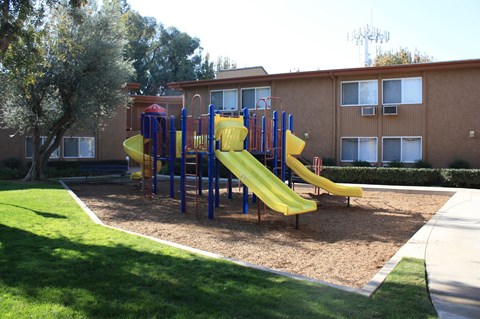 the playground is in front of an apartment building