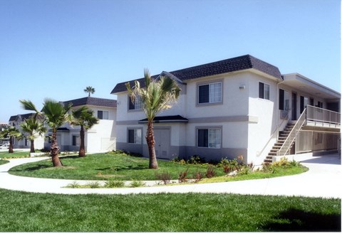 a large white house with palm trees in front of it
