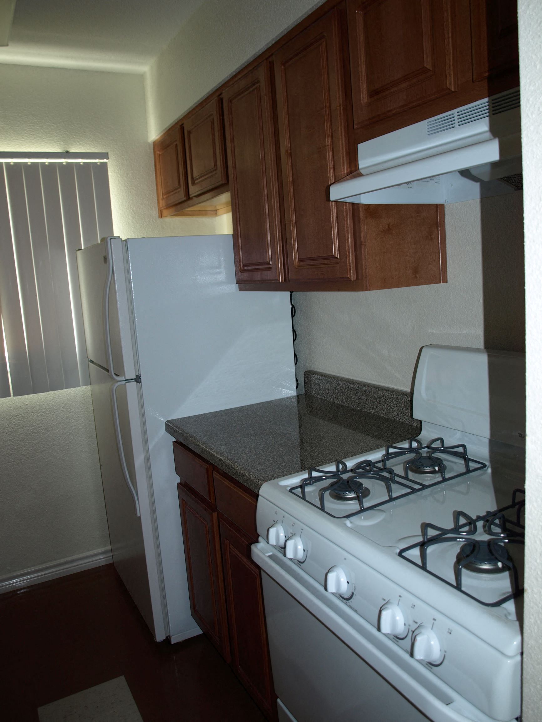 a kitchen with a stove and a refrigerator