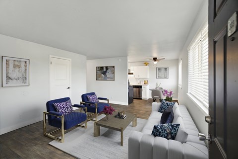 A living room with a white couch and a coffee table.