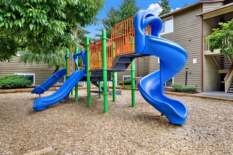 A blue and orange slide in a playground.
