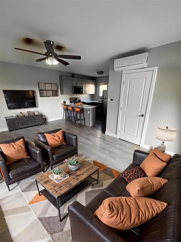 A living room with a brown leather couch and a wooden coffee table.