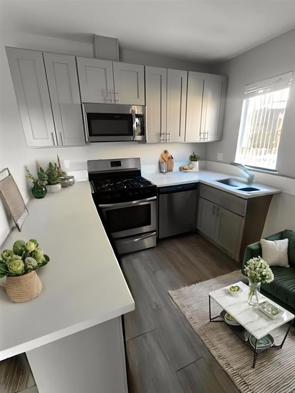 A modern kitchen with a stove top oven and microwave.