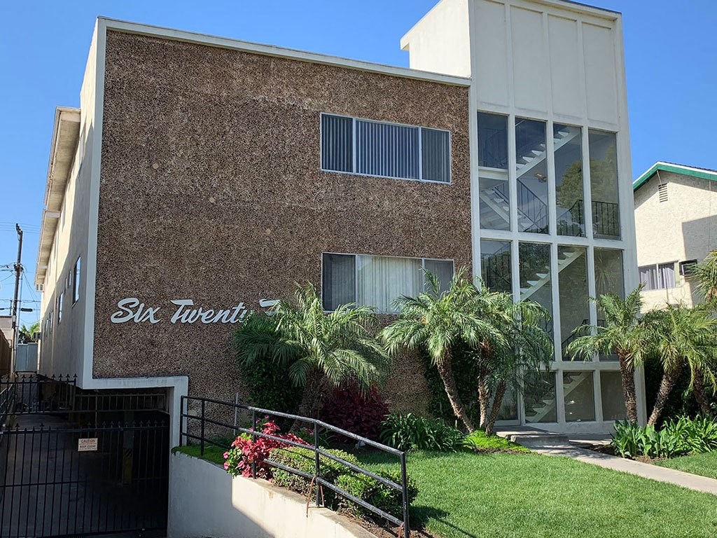 Signage, Garage, Building Front With Brick Detailing and Large Windows at Wilson Apartments in