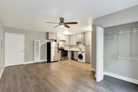 A kitchen with a refrigerator, dishwasher, and washing machine.at Federal Apartments, Los Angeles, CA 90025