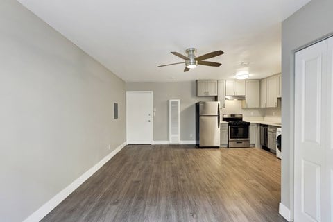A kitchen with a refrigerator, oven, and microwave.at Federal Apartments, Los Angeles, CA