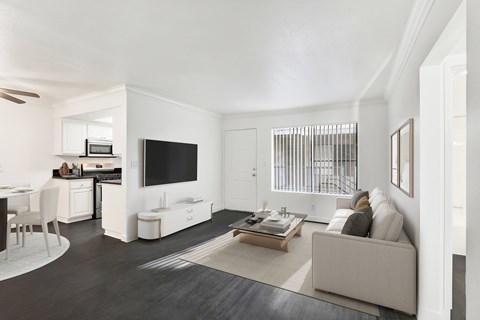 A modern living room with a grey couch and a television.