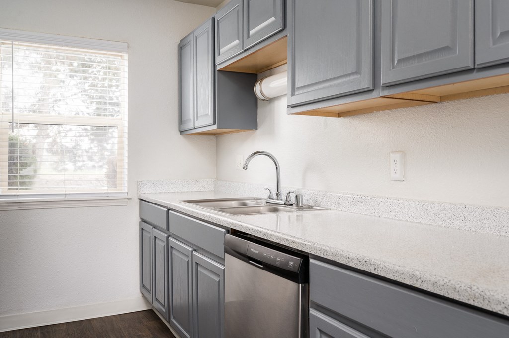 Bright Kitchen with cabinets and dishwasher at Kentwood Apartments, Washington , 98031