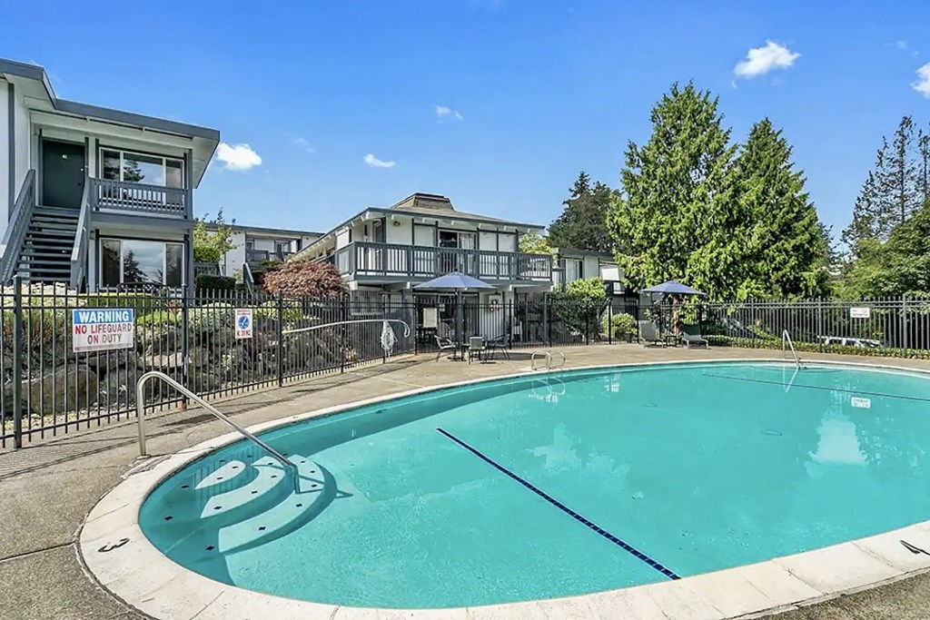 Pool with a warning sign on the fence at Capri Apartments, Mountlake Terrace, WA, Washington