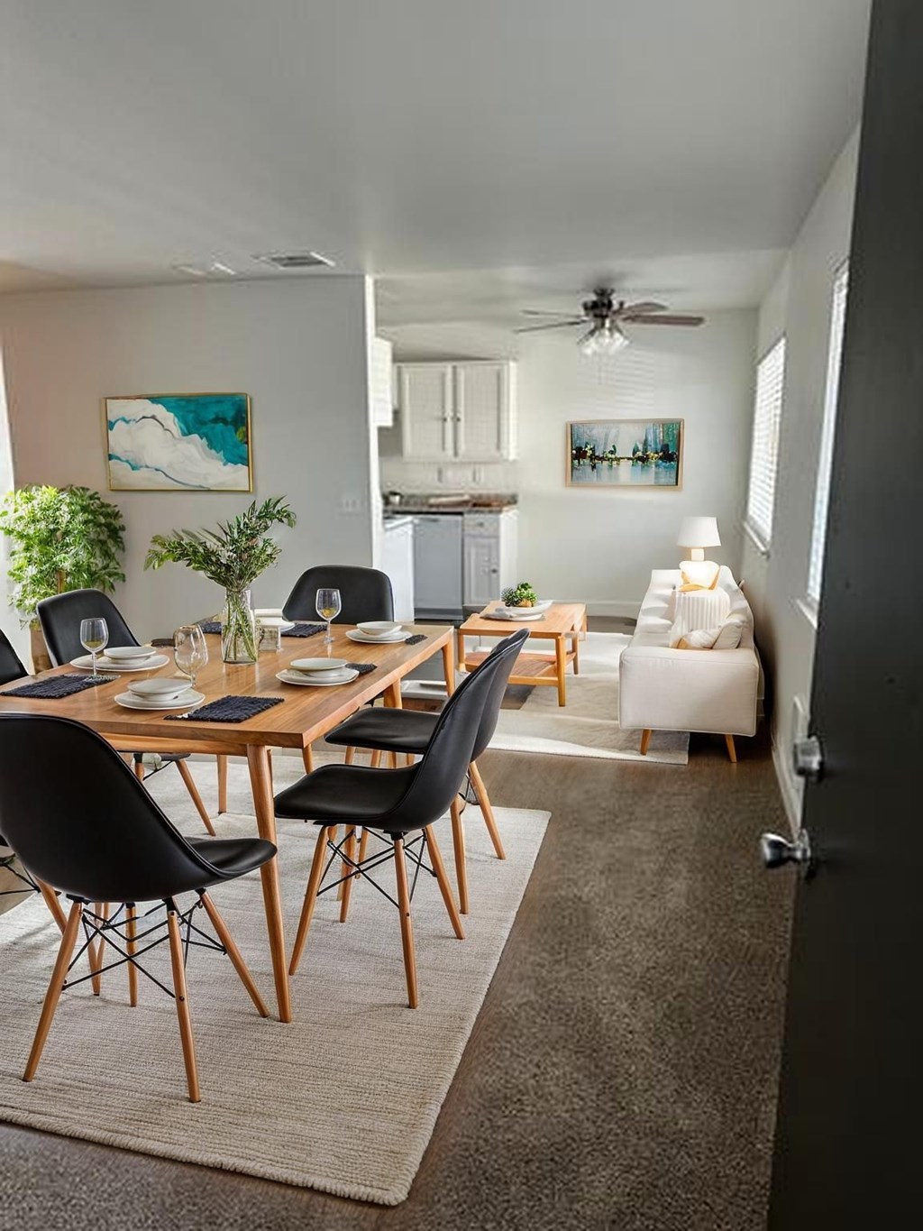 Living and dining room with large windows at Capri Apartments, Mountlake Terrace
