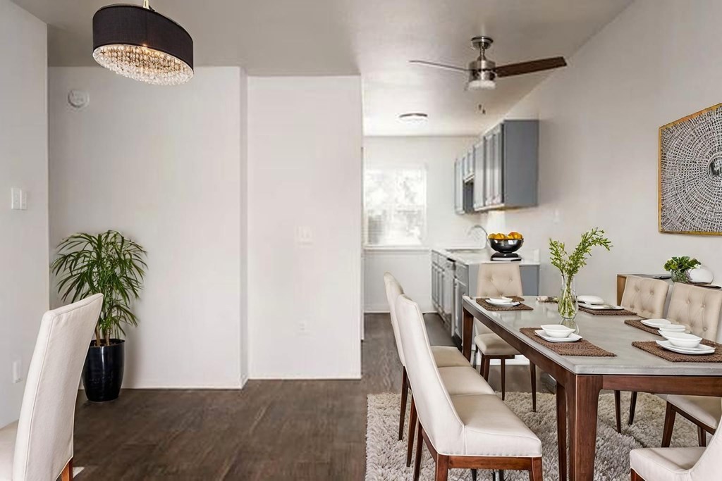 A modern dining room with a wooden table and chairs.
