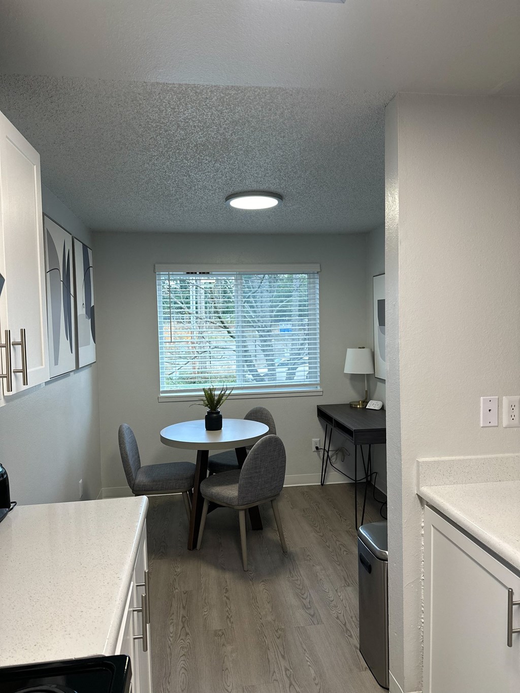 A kitchen with a table and chairs.