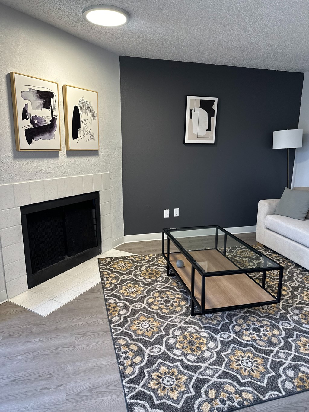 A living room with a fireplace and a coffee table.
